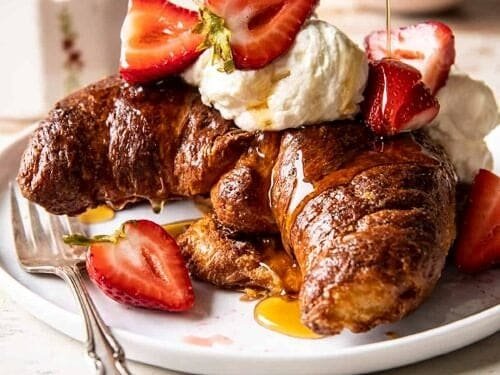 Baked Strawberry and Cream Stuffed Croissant French Toast.
